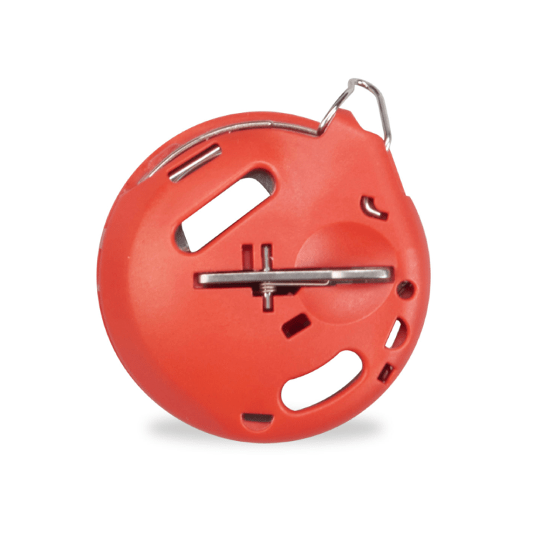 Red sewing machine bobbincase on a white background