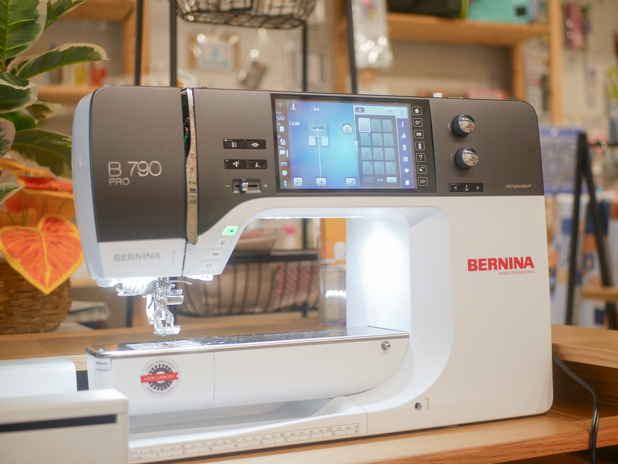 Bernina sewing machine on a wooden surface with a blurred background