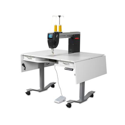 Sewing machine on a white table with a white background