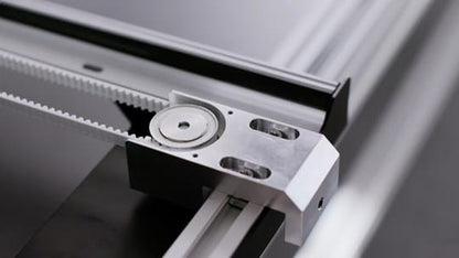 Close-up of a mechanical component with gears and metal parts on a gray background
