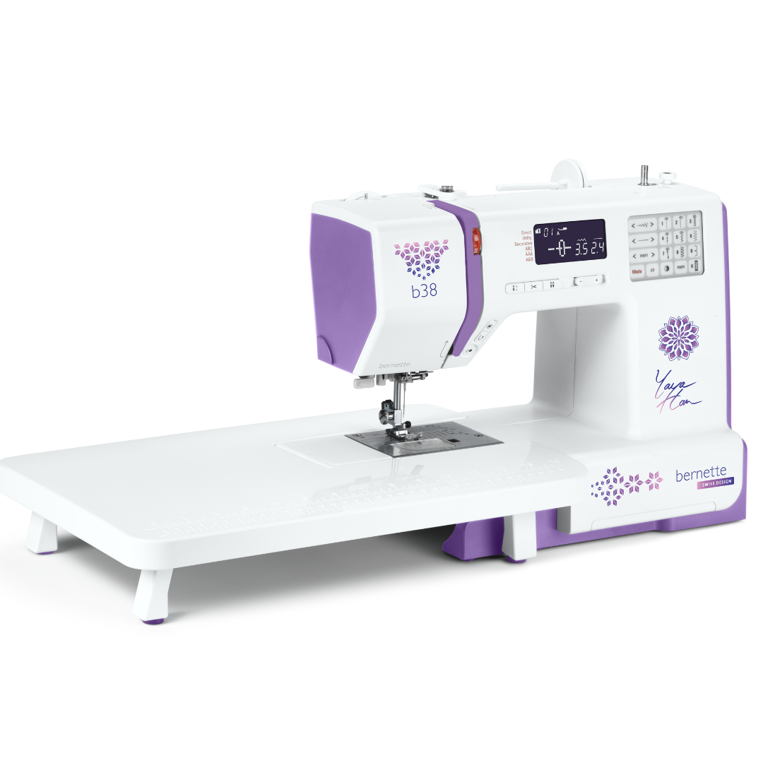 White and purple sewing machine on a white background